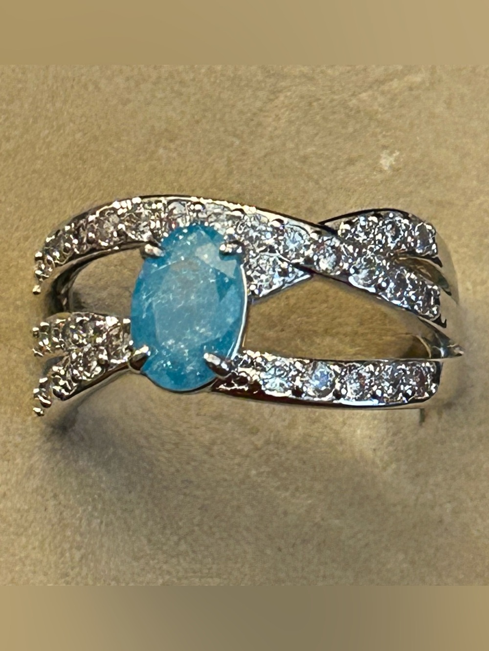 March-Crossing Paths: Lab Oval Aquamarine Ice Crystal Crisscross Ring